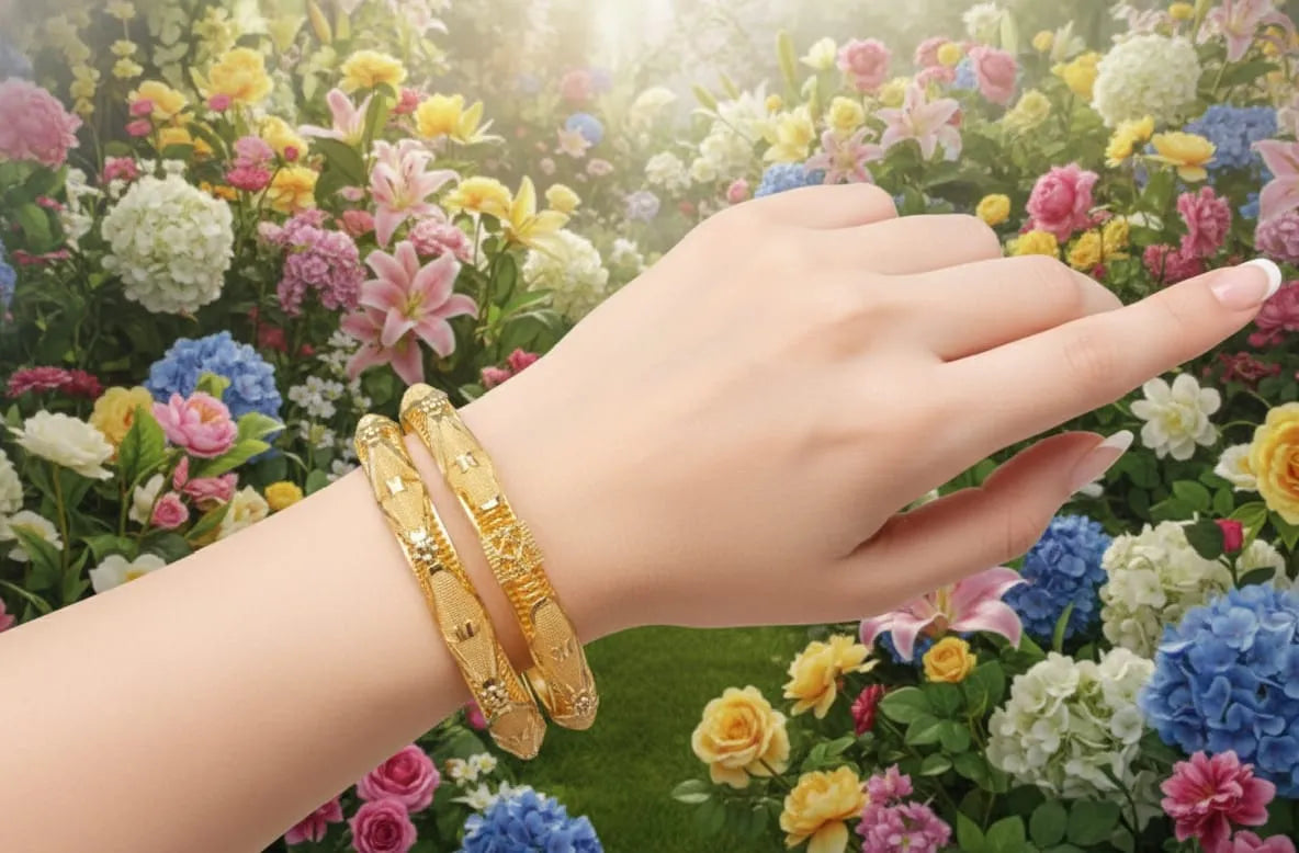 Hand wearing gold bracelets with a colorful floral background