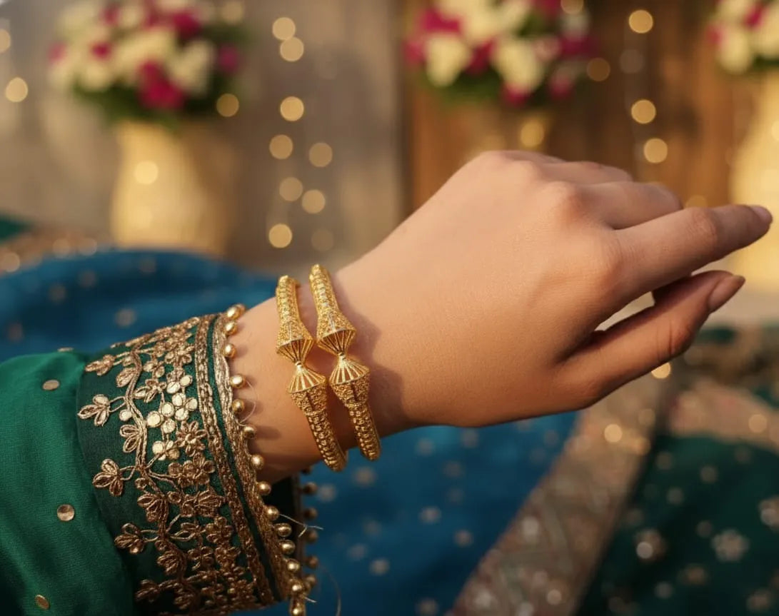 Gold bracelet on a marble surface with a white background