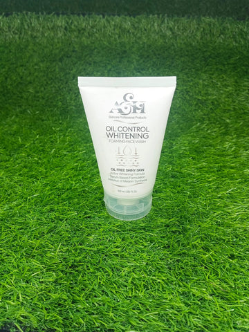 Tube of oil control whitening cream on a green grass background