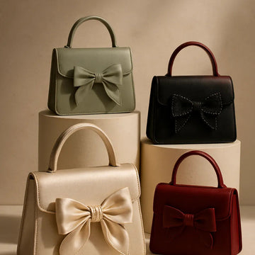 Four handbags with bow details on a beige background