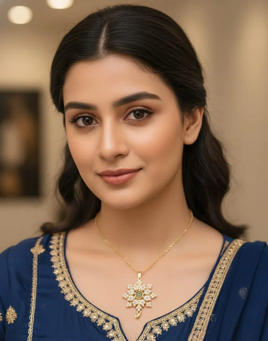 Woman wearing a blue traditional outfit with gold embroidery and a necklace.