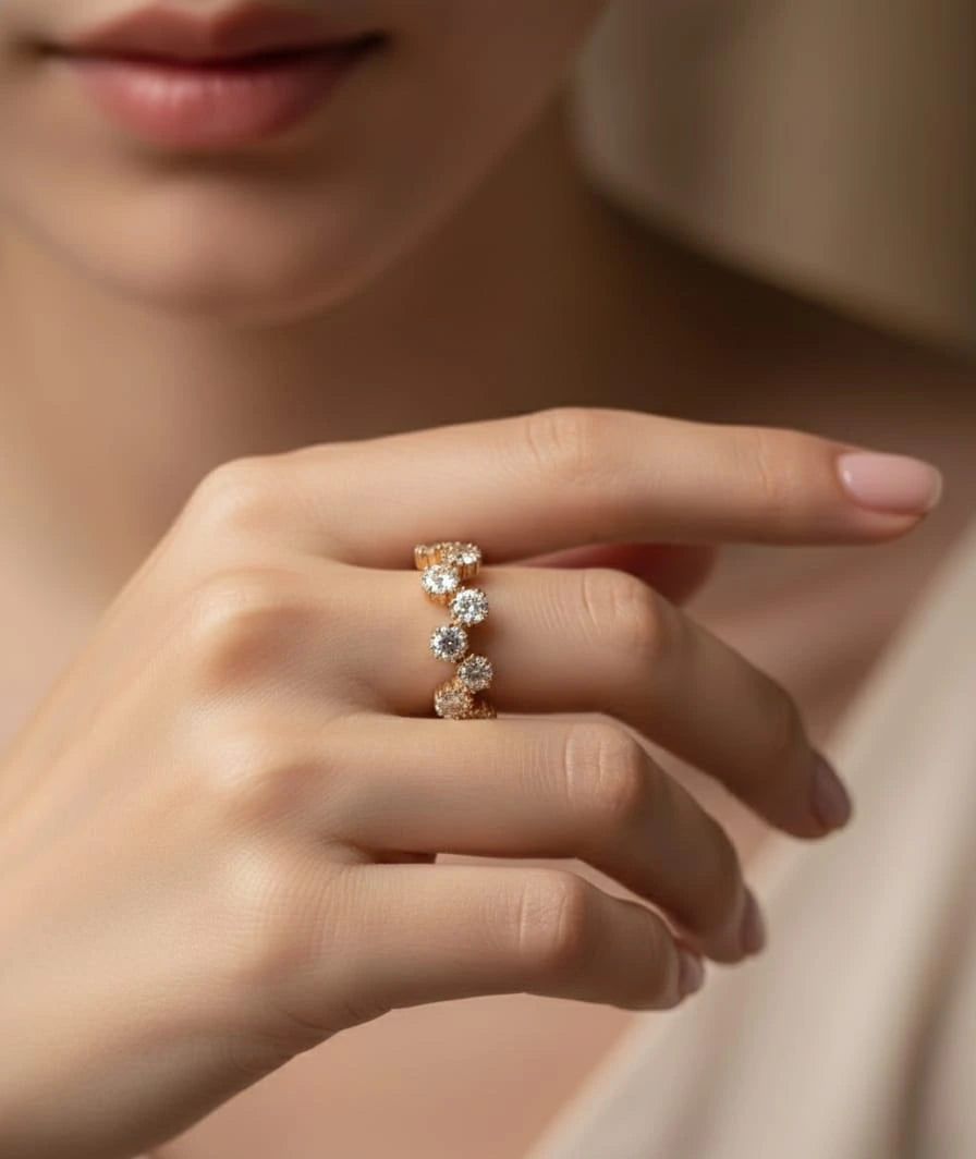 Close-up of a hand wearing a diamond ring on a neutral background
