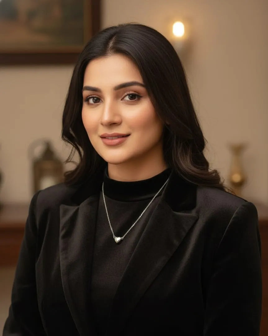 Woman wearing a black blazer in an indoor setting