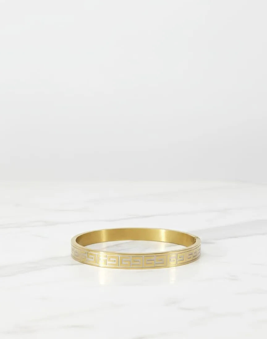 Woman wearing a gold bracelet on a white background