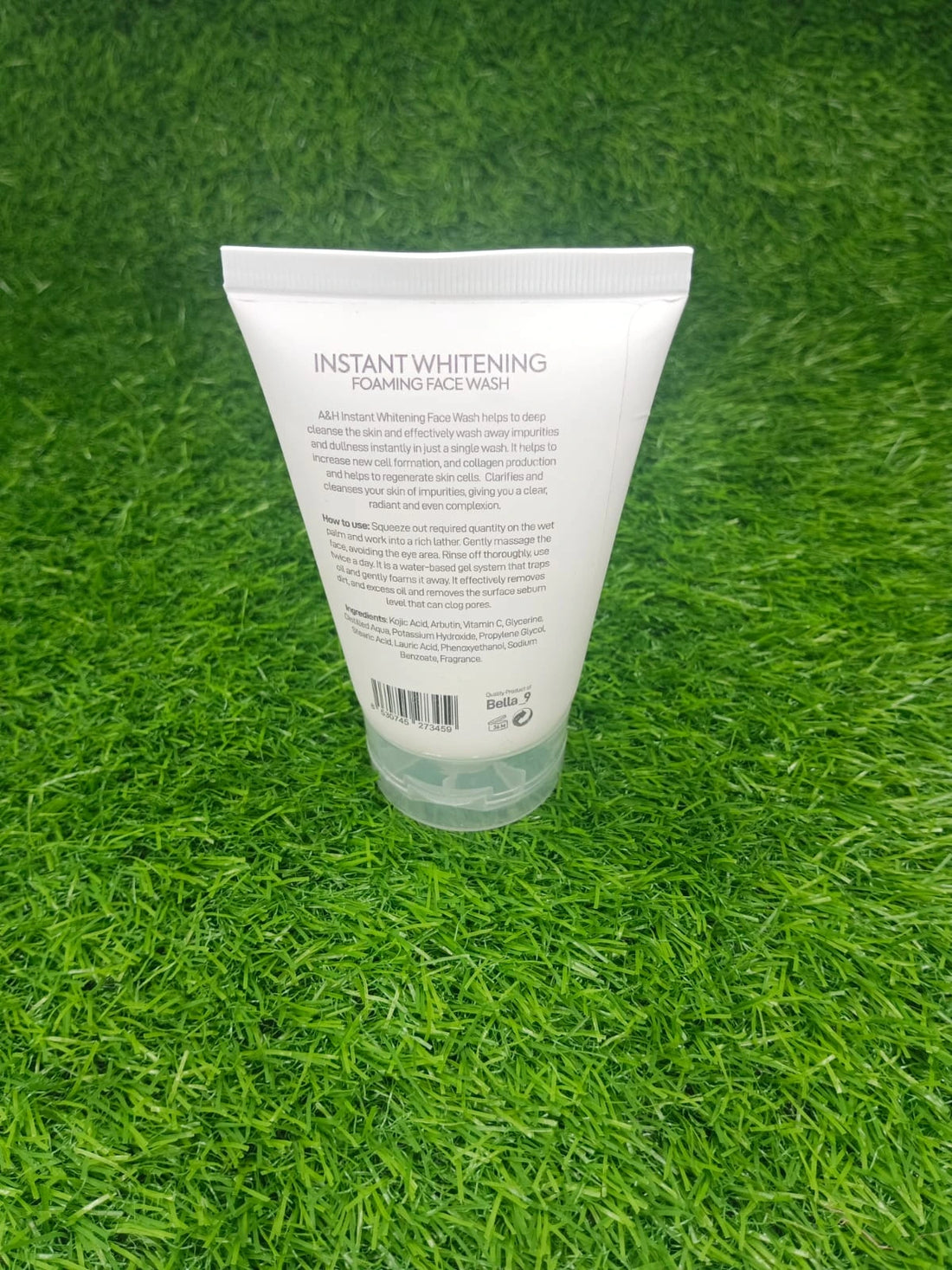 Tube of AGF Instant Whitening Deep Skin Cleanser on green grass