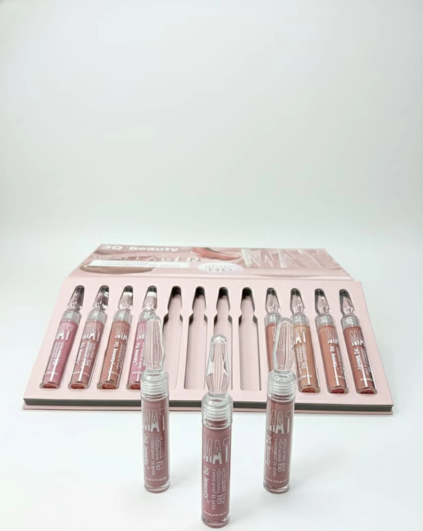 Set of lip gloss tubes with a pink packaging box on a white background