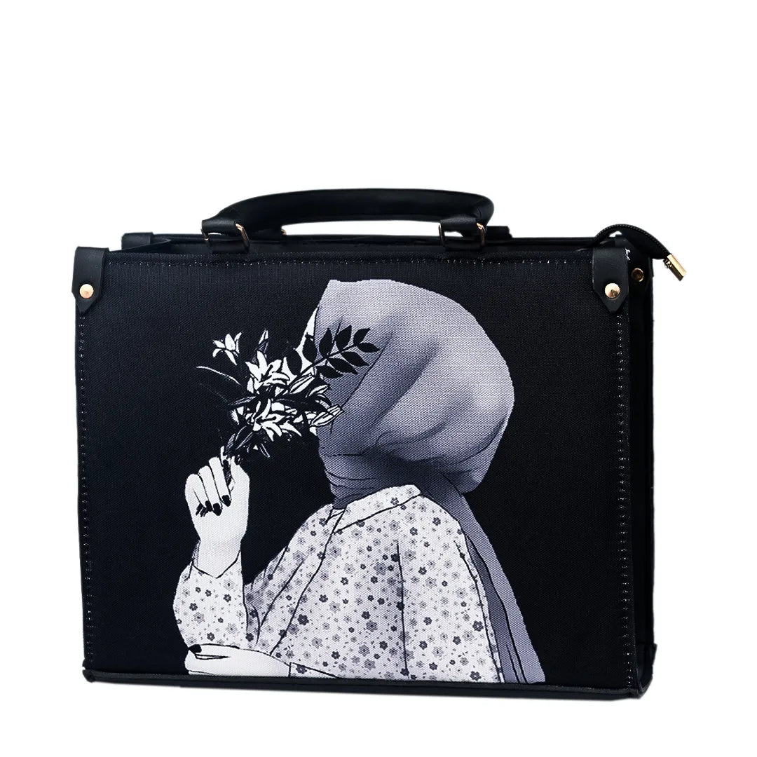 Black suitcase with a printed design of a woman in a headscarf on a marble table with plants in the background.