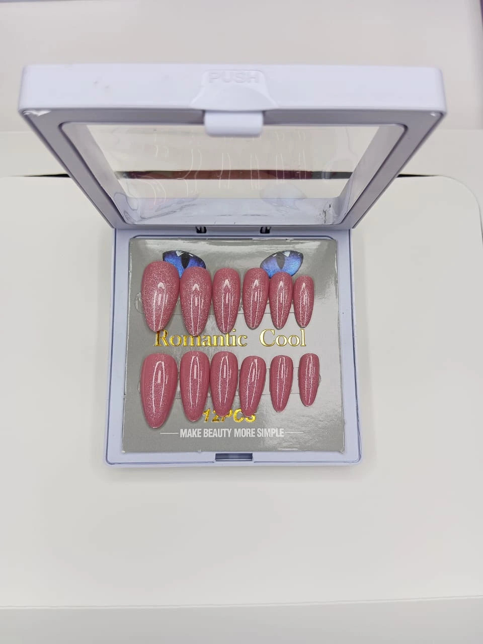 Set of pink nail art designs in a display case with 'Romantic Cool' text.