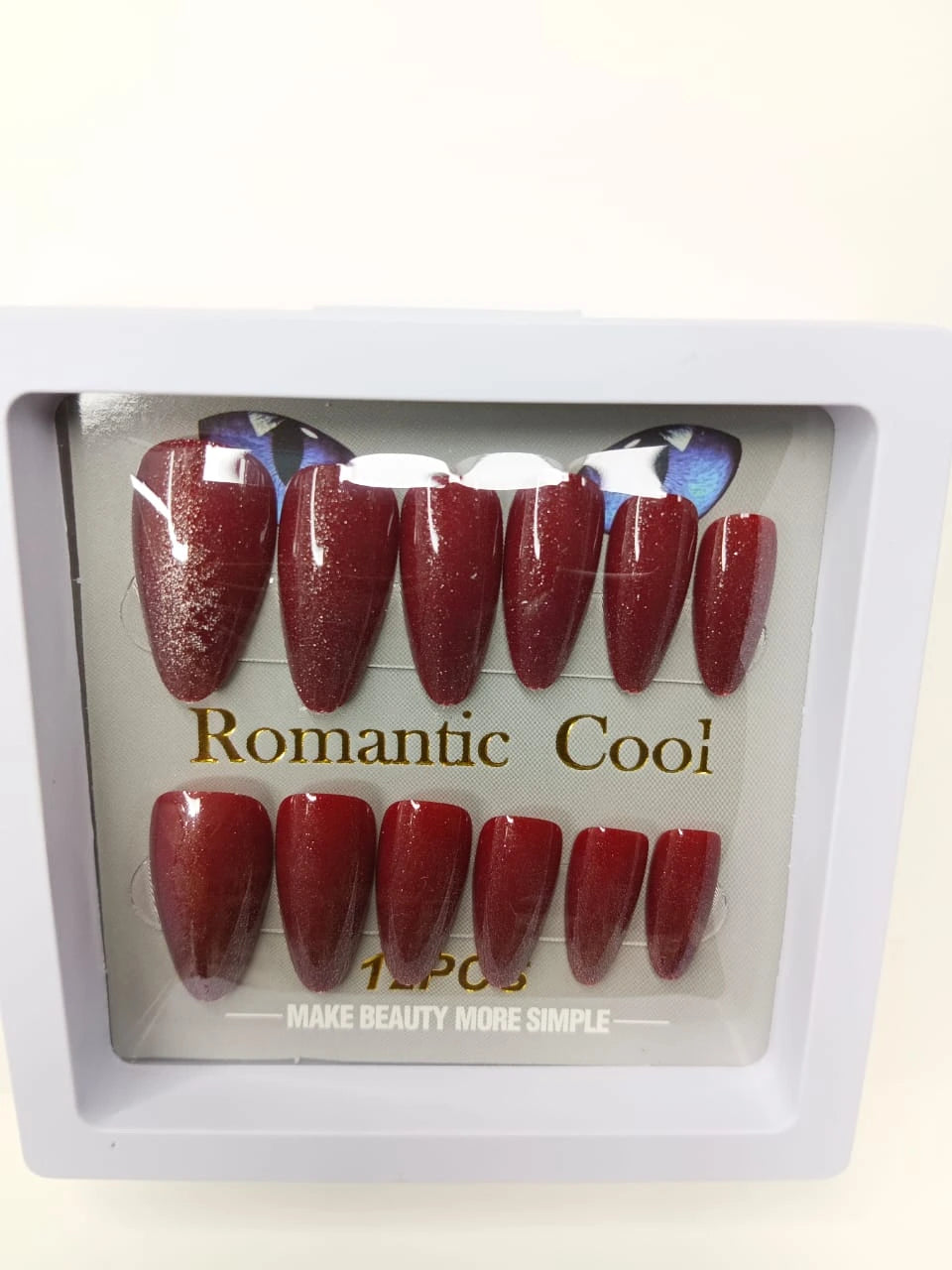 Red glittery nail tips in a clear packaging with 'Romantic Cool' branding.