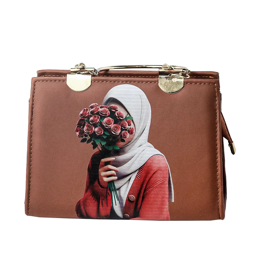Brown handbag with artistic design on a marble table with plants in the background
