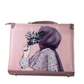 Pink suitcase with a design of a person wearing a headscarf holding flowers on a white background