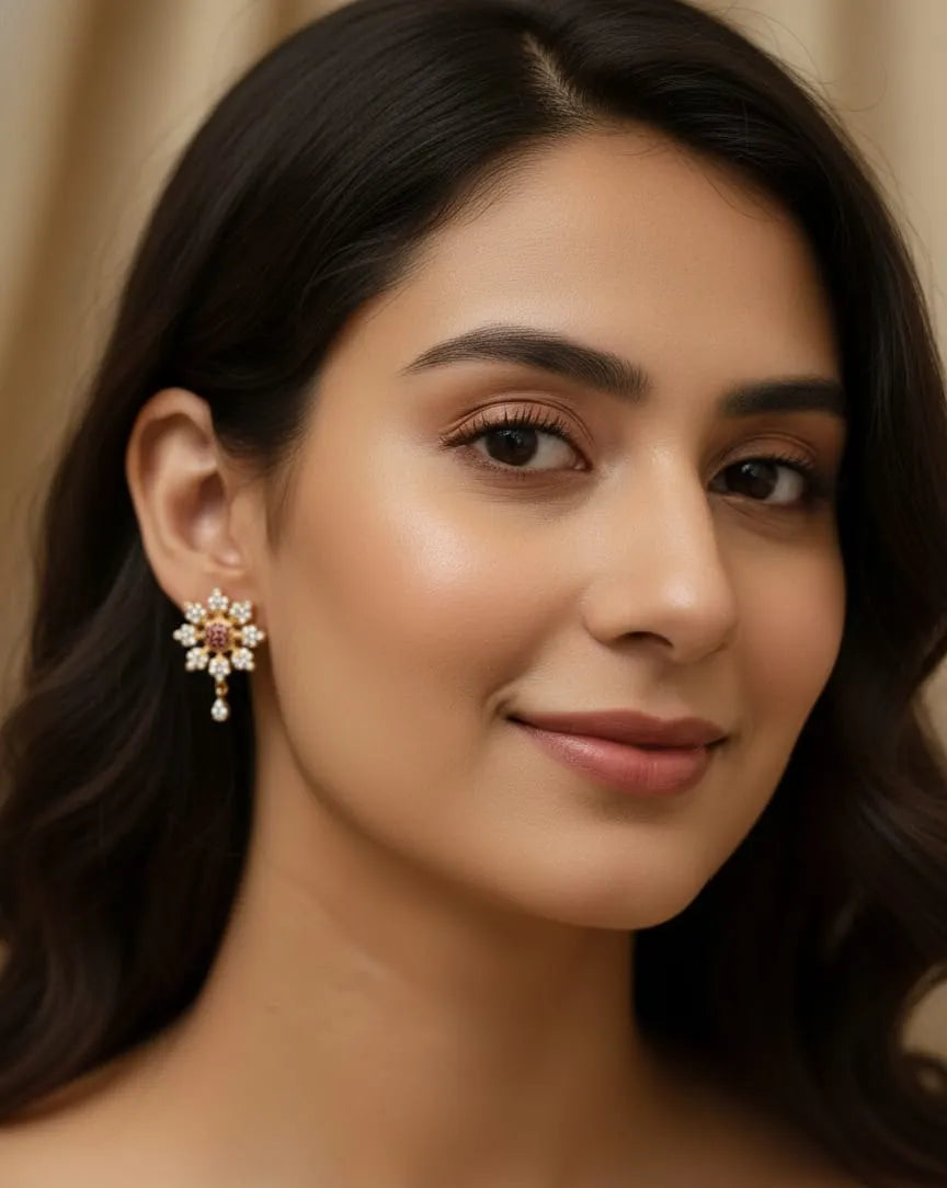 Close-up of a person wearing a decorative earring with a gemstone.