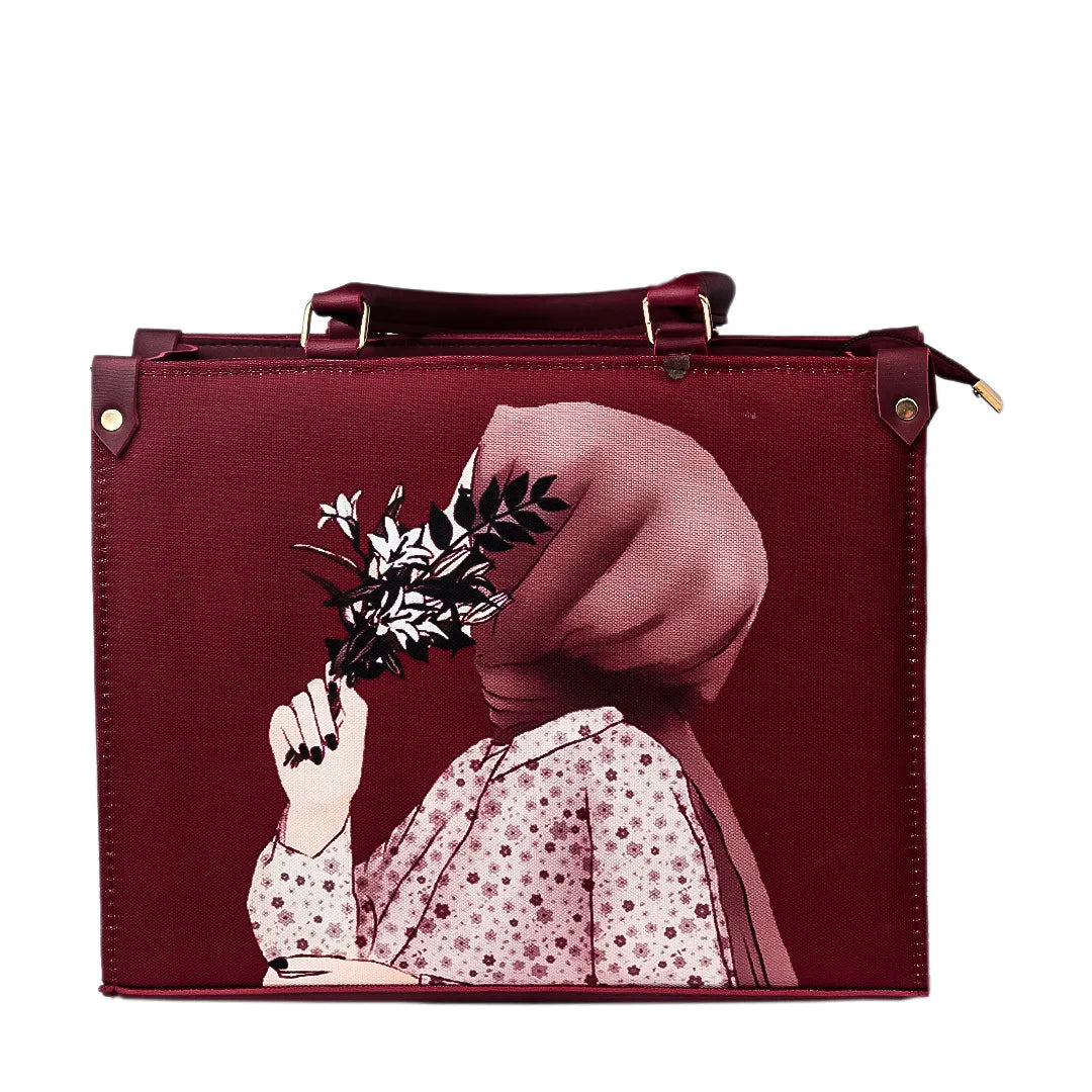 Maroon handbag with artistic design on a marble table against a light green wall with plants.