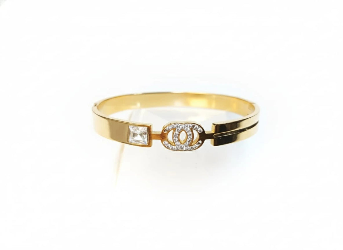 Gold bracelet with a diamond on a white background