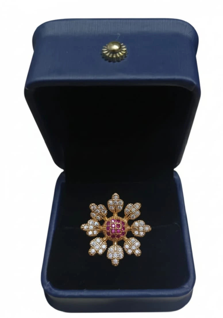 Decorative brooch with gemstones in a blue jewelry box