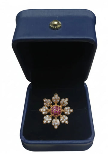 Decorative brooch with gemstones in a blue jewelry box