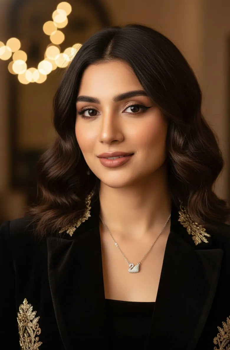 Silver swan pendant necklace on a dark textured background