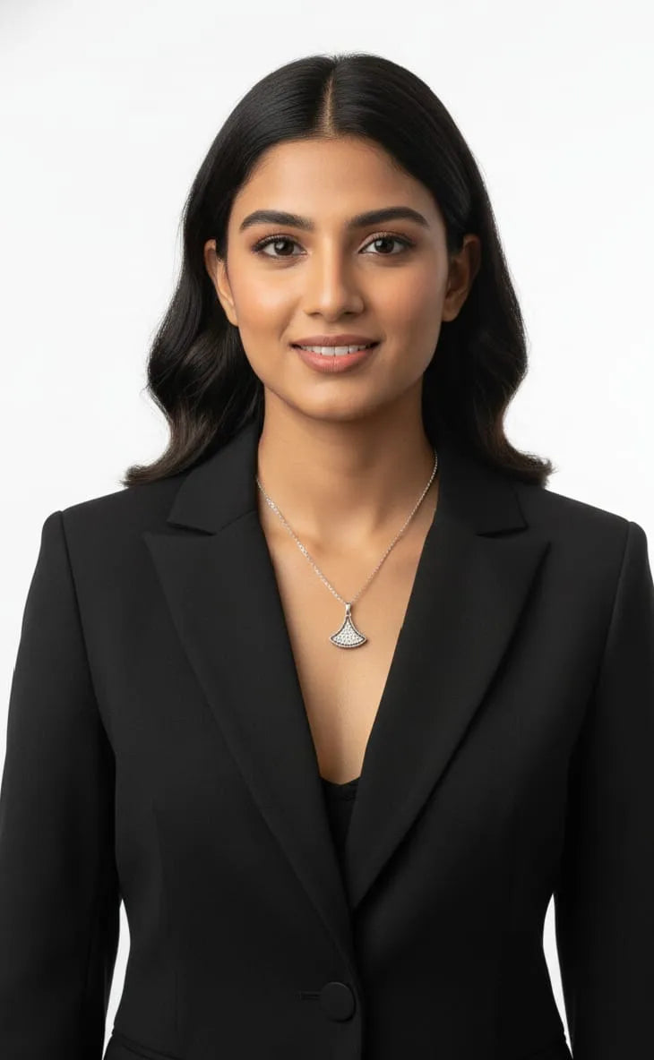 Silver necklace with a pendant on a dark fabric background
