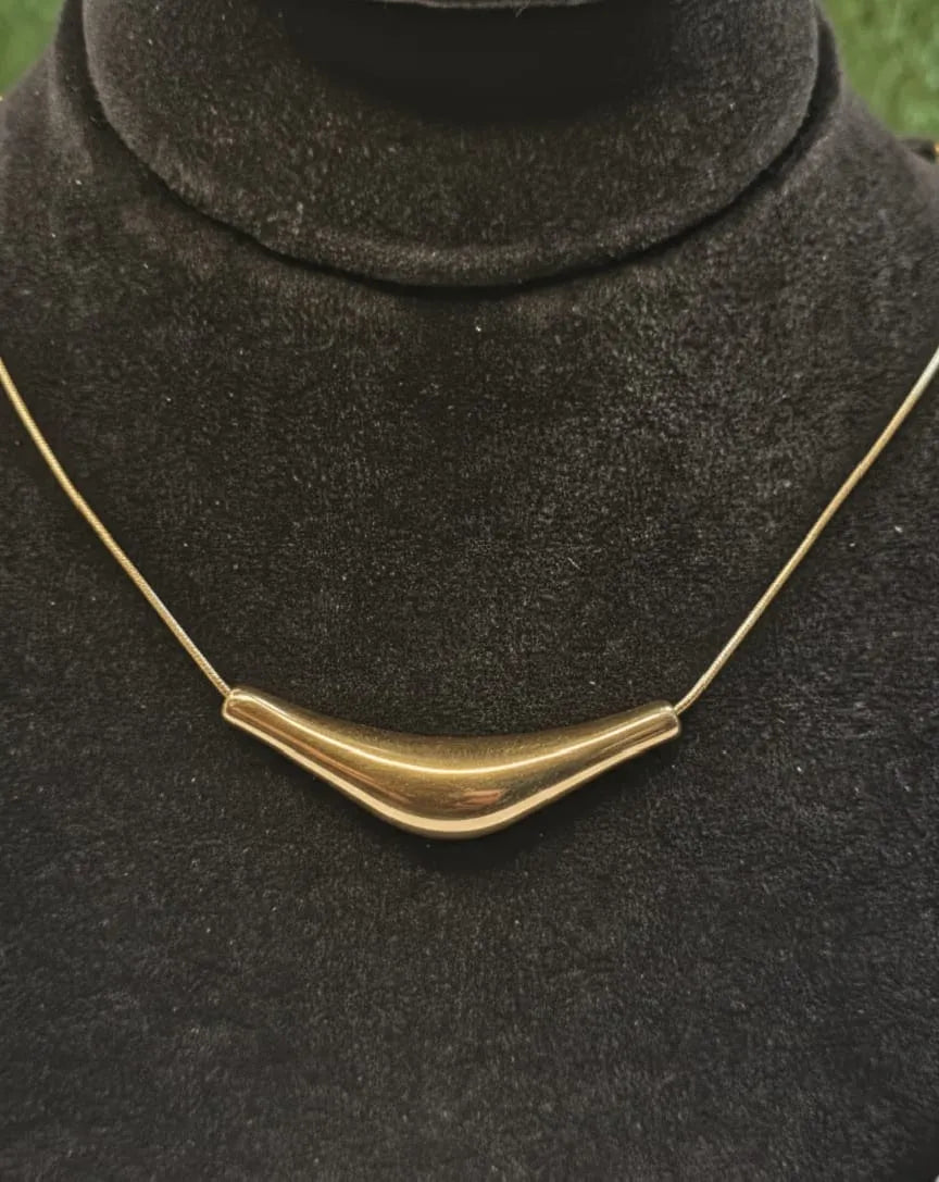 Woman wearing a black outfit with gold accents indoors