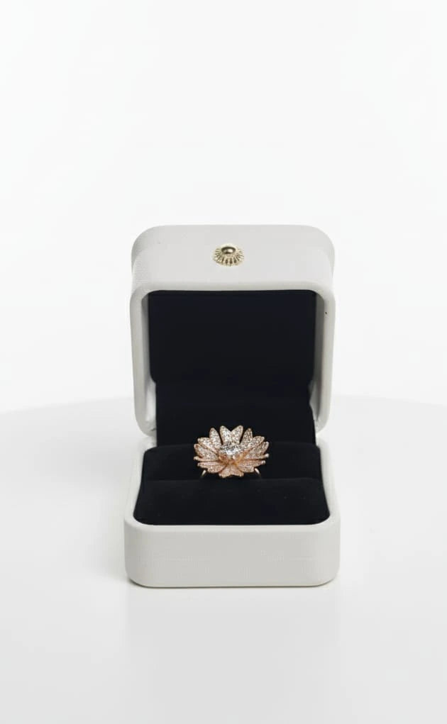 Hand wearing a decorative ring with a blurred jewelry store background