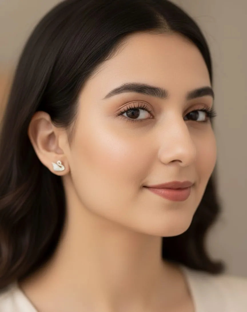 ear wearing a diamond earring with a blurred