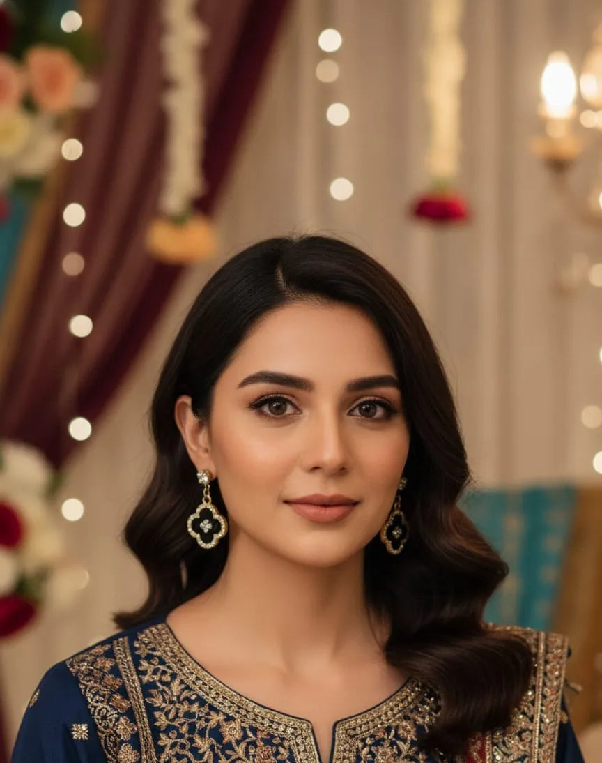 Close-up of a woman wearing a black clover-shaped earring with gold and clear stones.