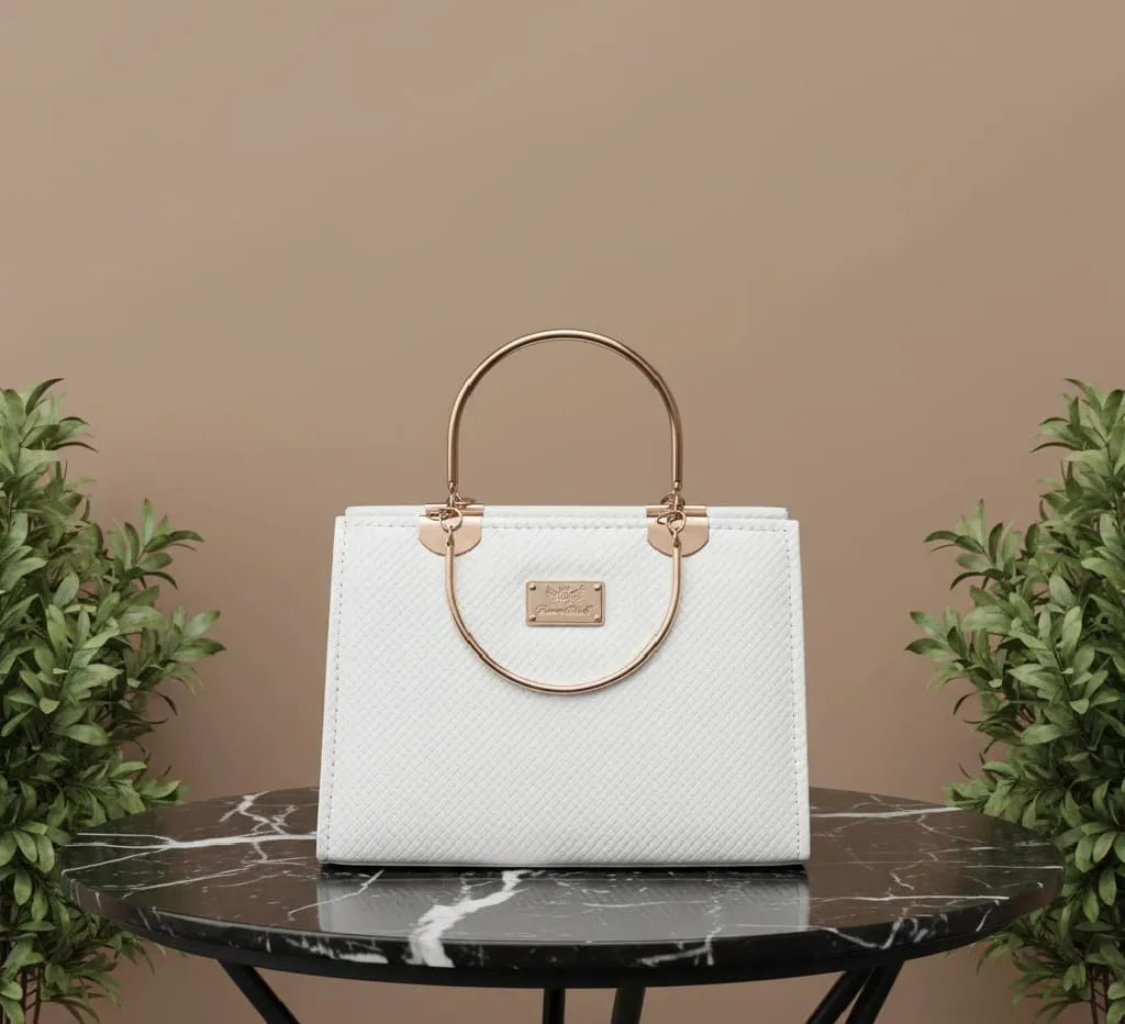 White handbag with gold accents on a black marble table against a beige background