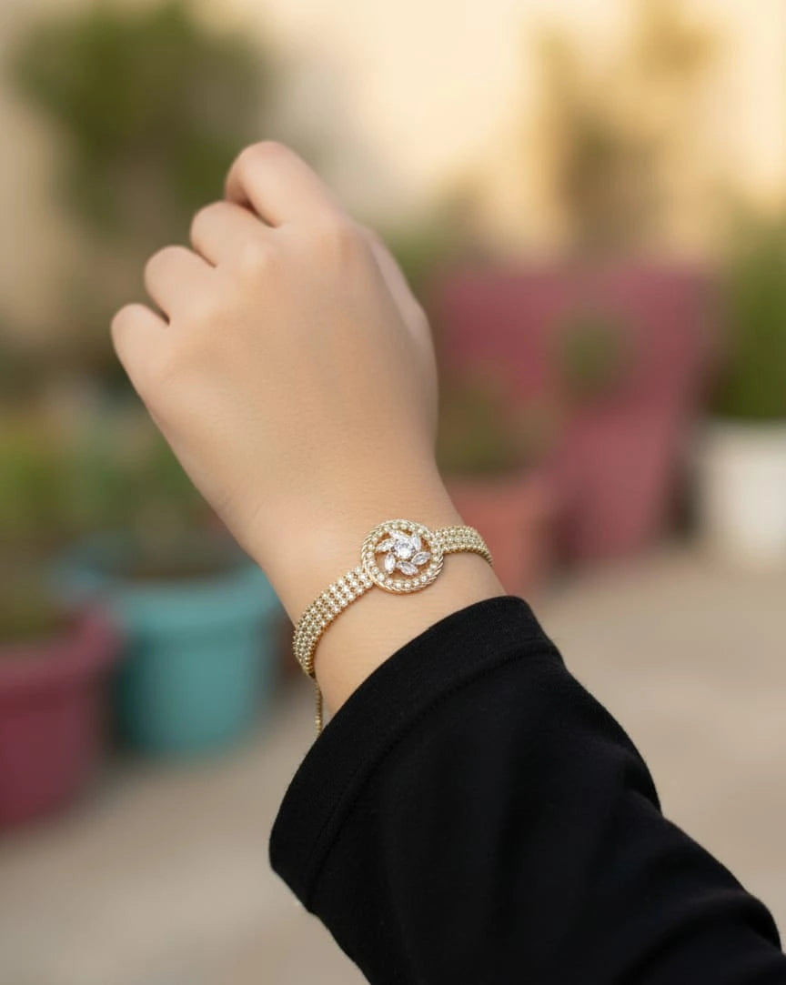 Hand wearing a decorative bracelet with a blurred outdoor background