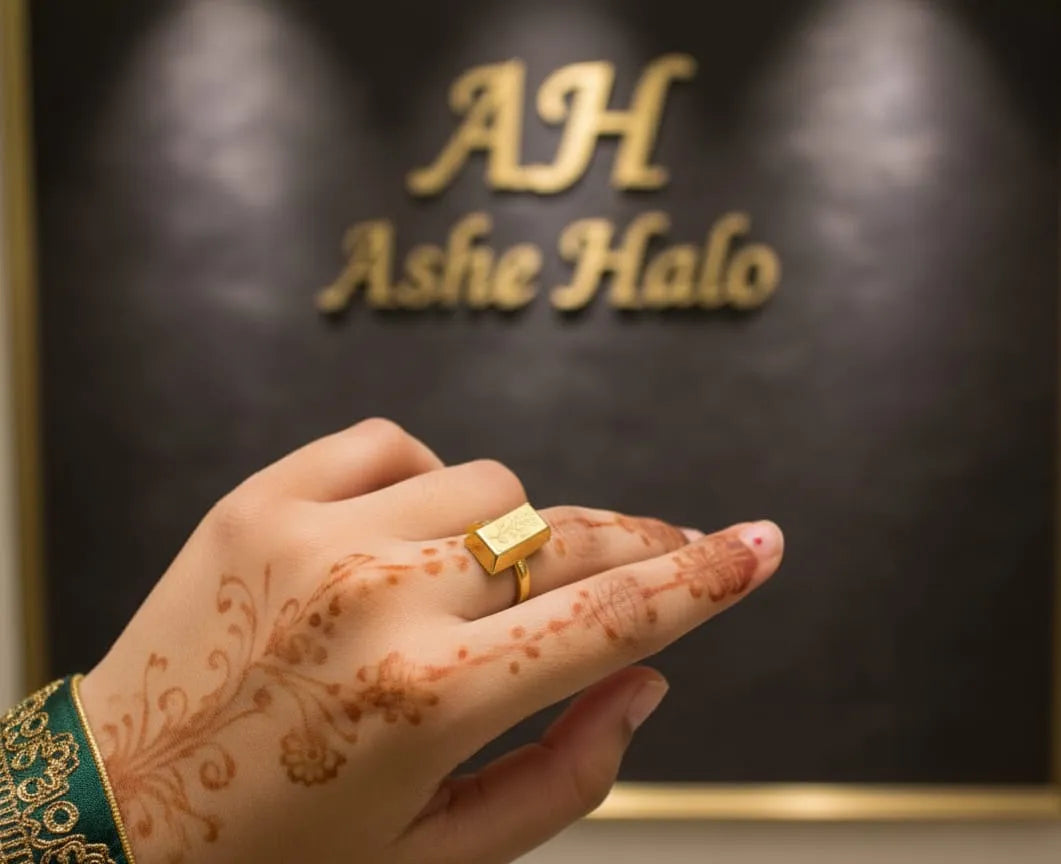 Hand wearing a gold ring with 'AH Ashe Halo' logo in the background